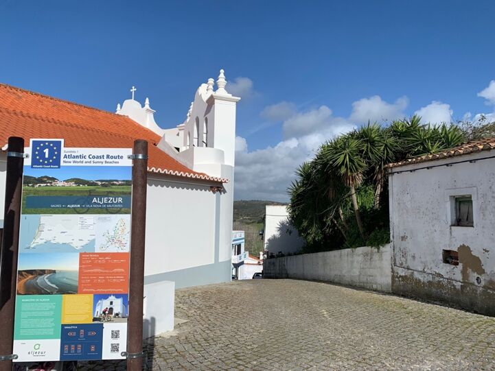 The EuroVelo 1 information sign in Aljezur (Portugal), located between the church and the old castle.