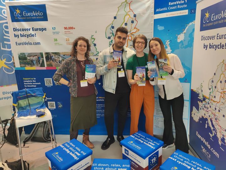 The EuroVelo Management Team at the EuroVelo booth during Velo-city 2023 with the new Overview Map.